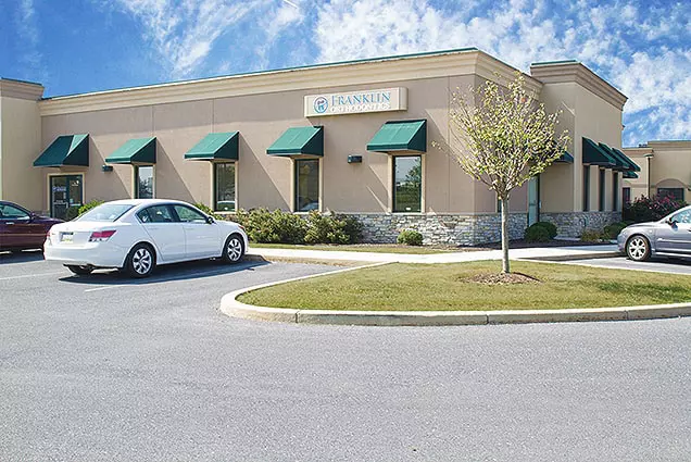 A white car parked in front of a building.