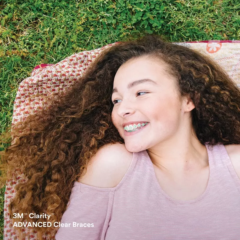 A woman laying on the ground with her hair flying in the air.